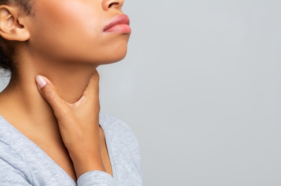 Black woman touching her neck, having pain in throat
